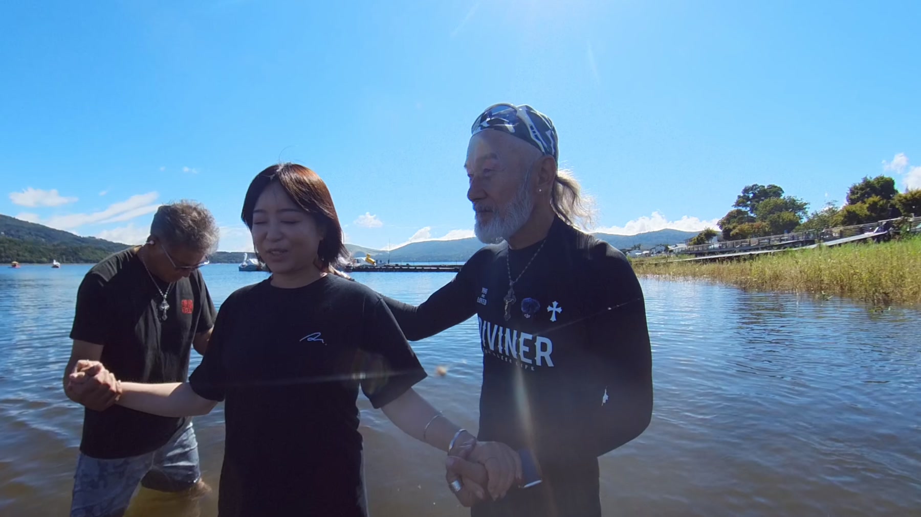 山中湖の水の中で、洗礼を前にアーサー先生らと祈るわかさん