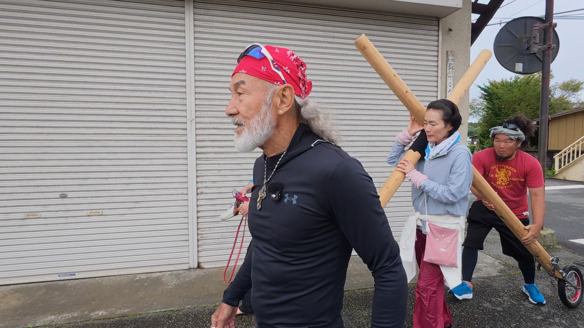 十字架は次の人の肩へ。担ぐ人が替わるたびに、隣で交わす話も変わっていった。